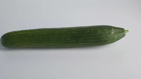 Cucumber placed on flat surface shown from different angles 動画素材 338120740