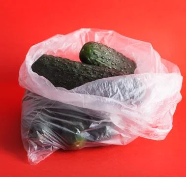 Cucumber in plastic pacts on a red background Stock Photos