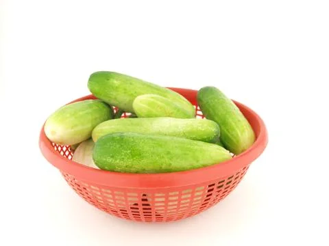 Cucumber on red basket Stock Photos