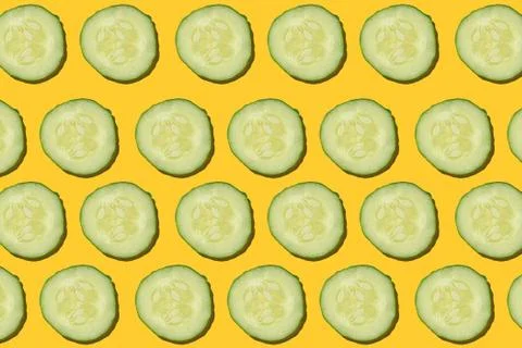 Cucumber regular pattern on a yellow background. Stock Photos