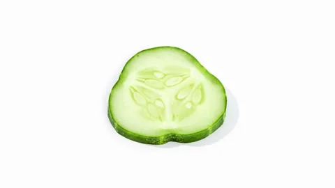 Cucumber slice isolated rotating on white background Stock Footage 135342956