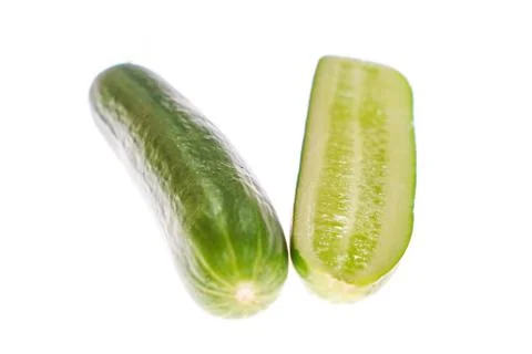 Cucumber with a slice on white background Stock Photos