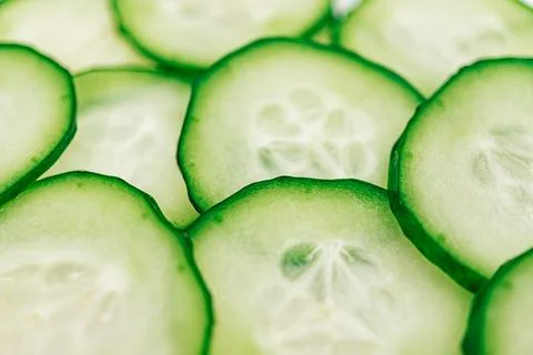 Cucumber slices arranged in a scattered pattern, showcasing vibrant green c.. Stock Photos