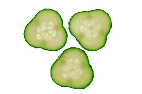 Cucumber slices arranged in a triangular formation against a white background Stock Photos