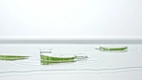 Cucumber slices falling into water Stock-Footage 241348989