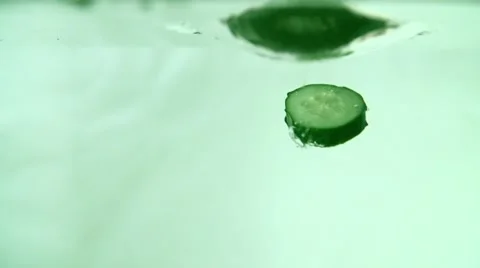 Cucumber Slices Falling into Water on White Video stock 59305384