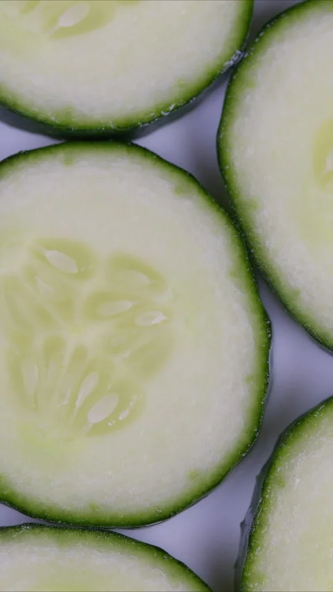 Cucumber slices presented. Neatly arranged cucumber pieces on light background s Stock Footage 337348671