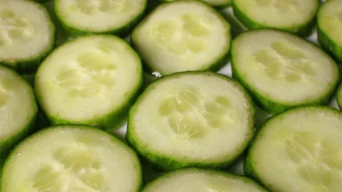 Cucumber slices rotating pattern macro texture background backdrop footage video Stock Footage 91378523