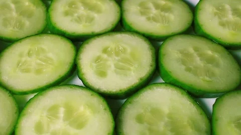 Cucumber slices rotating pattern macro texture background backdrop footage video Stock Footage 91381579