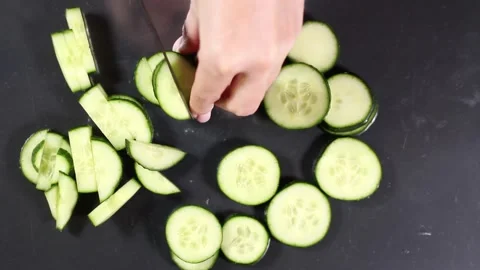Cucumber slicing on gray background close-up top view Video stock 132791294