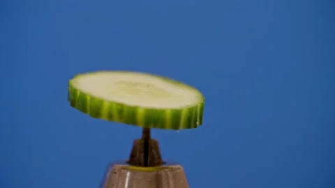 Cucumber spinning on blue screen 库存影片 220755801
