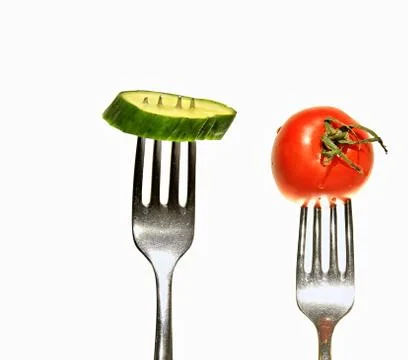 Cucumber tomato with fork Stock Photos
