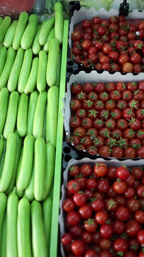 Cucumbers and cherry tomatoes display Stock Footage 331023761