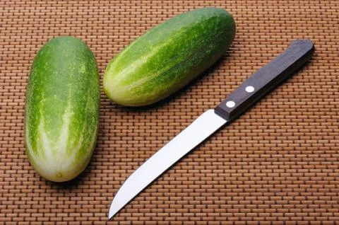 Cucumbers and knife Stock Photos