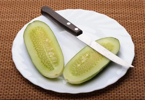 Cucumbers and knife Stock Photos