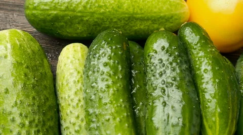 Cucumbers and tomatoes, pan, on background wooden table, top view Stock Footage 65908280