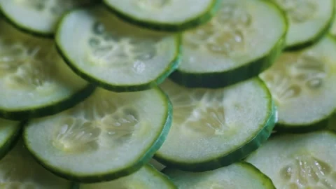 Cucumbers are cut into thin slices and arranged neatly to showcase their texture 库存影片 338290243