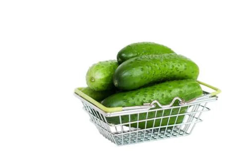 Cucumbers in a basket on a white background Stock Photos