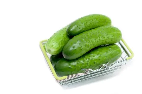 Cucumbers in a basket on a white background Stock Photos