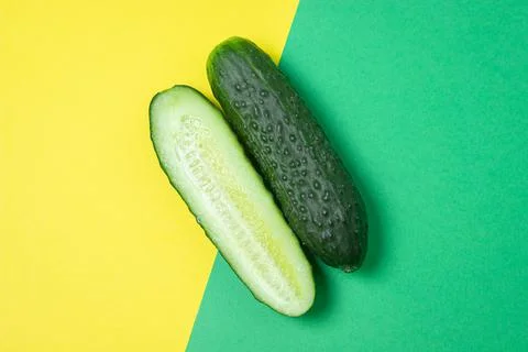 Cucumbers on a colored background. The cucumber is cut lengthwise. Stock Photos