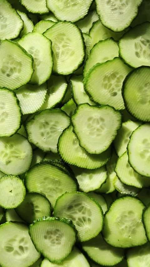 Cucumbers cut into circles close-up rotate. Cucumber slices macro Stock Footage 312691124