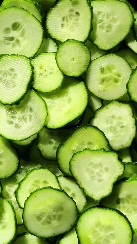 Cucumbers cut into circles close-up rotate. Cucumber slices macro Stock Footage 312691150
