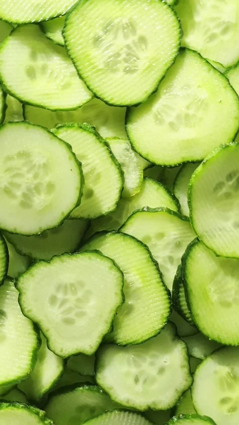 Cucumbers cut into circles close-up rotate. Cucumber slices macro Stock Footage 312691156