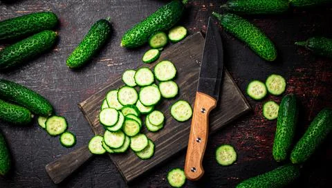Cucumbers cut on a cutting board. Stock Photos