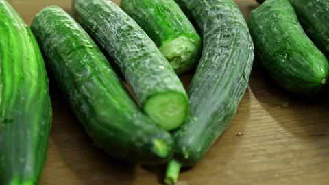 Cucumbers Displayed on Vegetable Stall at Farmers Market, Slow Motion 스톡 동영상 332355315