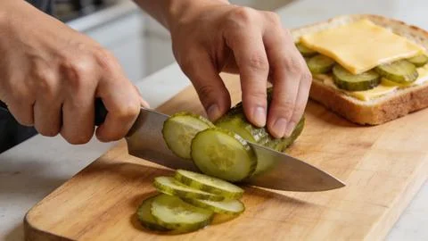 Cucumbers hands making a sandwich breakfast time preparation food bread  Stock Photos