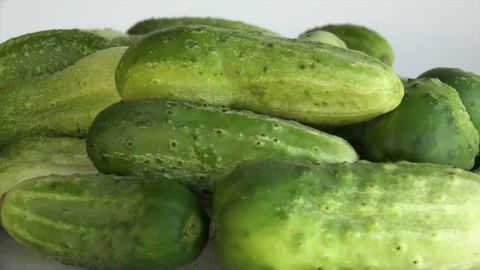 Cucumbers spinning around on a plate in a studio Stock Footage 239594724