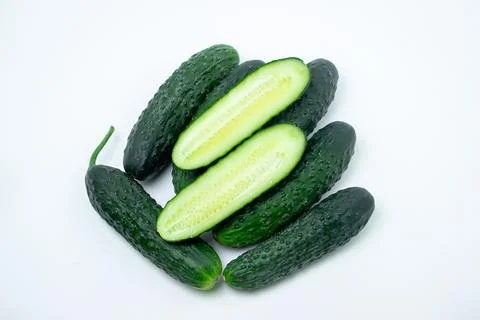 Cucumbers on a white background. The cucumber is cut lengthwise.  Stock Photos