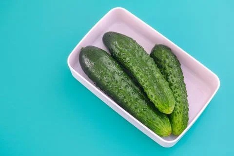 Cucumbers in a white container Stock Photos