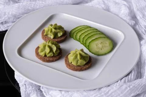 Cucumbers on a white plate. Stock Photos