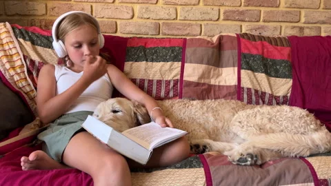 Cudding her dog reading a book Video stock 300994282
