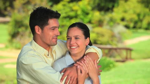 Cuddly couple sitting on a grass Stock Footage 2921331