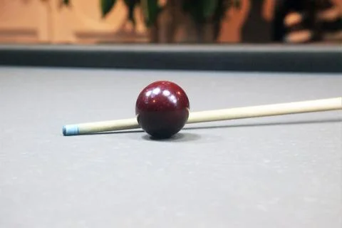 Cue on a grey billiard table Stock Photos