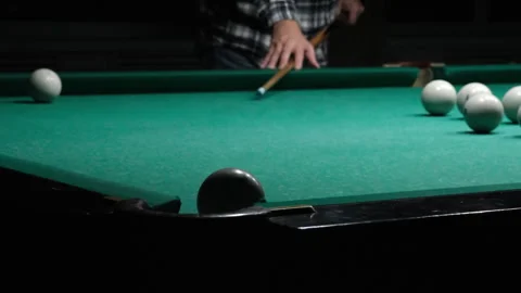 Cue in man's hand hits white ball and it falls into pocket. Russian billiards Stock Footage 259567583