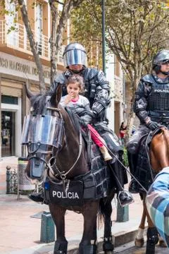 Cuenca, Ecuador - August 13, 2015 - Small girl sits on a horse in the lap of  Stock-Fotos