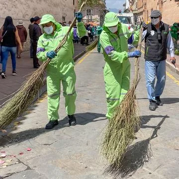Cuenca, Ecuador, Dec 24, 2021 - A team of sanitation workers cleans the stree Stock Photos