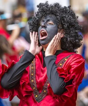 Cuenca, Ecuador - December 24, 2015 - Young men in Black Face costumes for Stock Photos