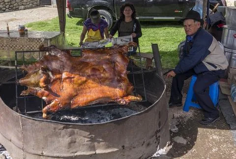 Cuenca, Ecuador - Nov 22, 2012: Man BBQs full pig Stock Photos