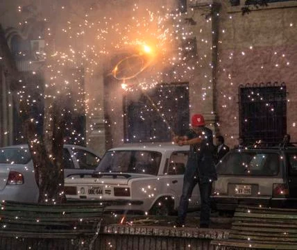 Cuenca, Ecuador - Nov 29, 2012: Man holds fireworks pinwheel Stock Photos