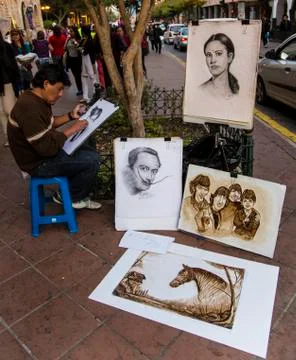 Cuenca, Ecuador - Nov 3, 2012: Street artist draws portraits Stock Photos