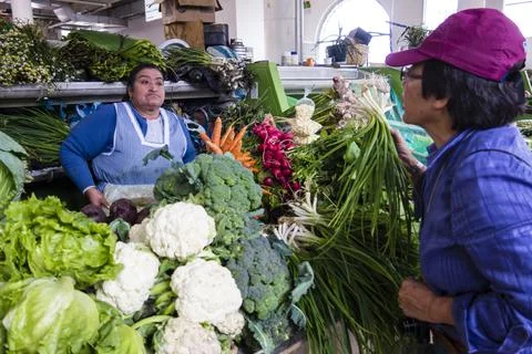 Cuenca, Ecuador - Nov 9, 2012: Woman buys vegetables Stock Photos