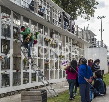 Cuenca, Ecuador - November 1, 2015 -people service a grave in a cemetary cond Stock Photos