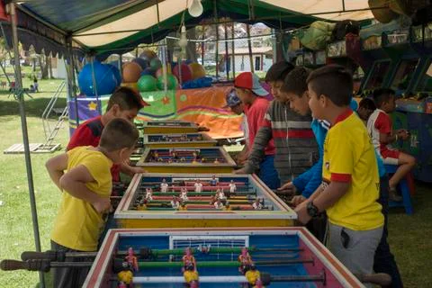 Cuenca, Ecuador - November 2, 2017 - Boys play arcade games at a festival in Stock Photos