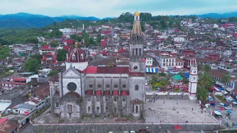 CUETZALAN, PUEBLA, MEXICO - AUGUST 7, 2025: Aerial video town square and church Stock Footage 317665902