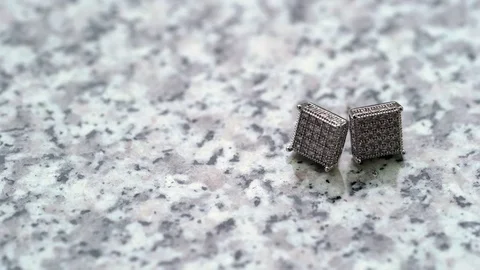 Cuff links on marble background Stock Footage 73748373