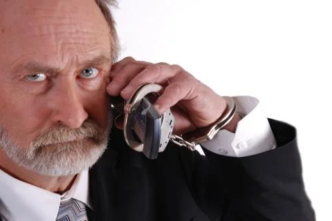 Cuffed to mobile phone Stock Photos